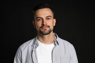 Photo of Portrait of handsome middle aged man on black background