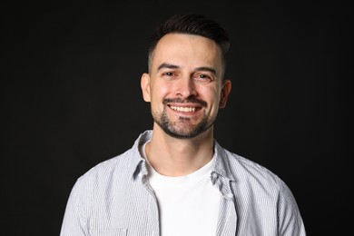 Photo of Portrait of handsome middle aged man on black background