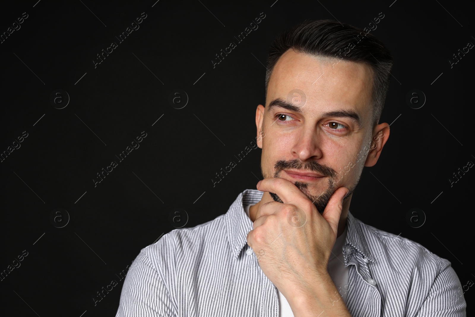 Photo of Portrait of handsome middle aged man on black background, space for text