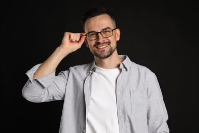 Photo of Portrait of handsome middle aged man on black background