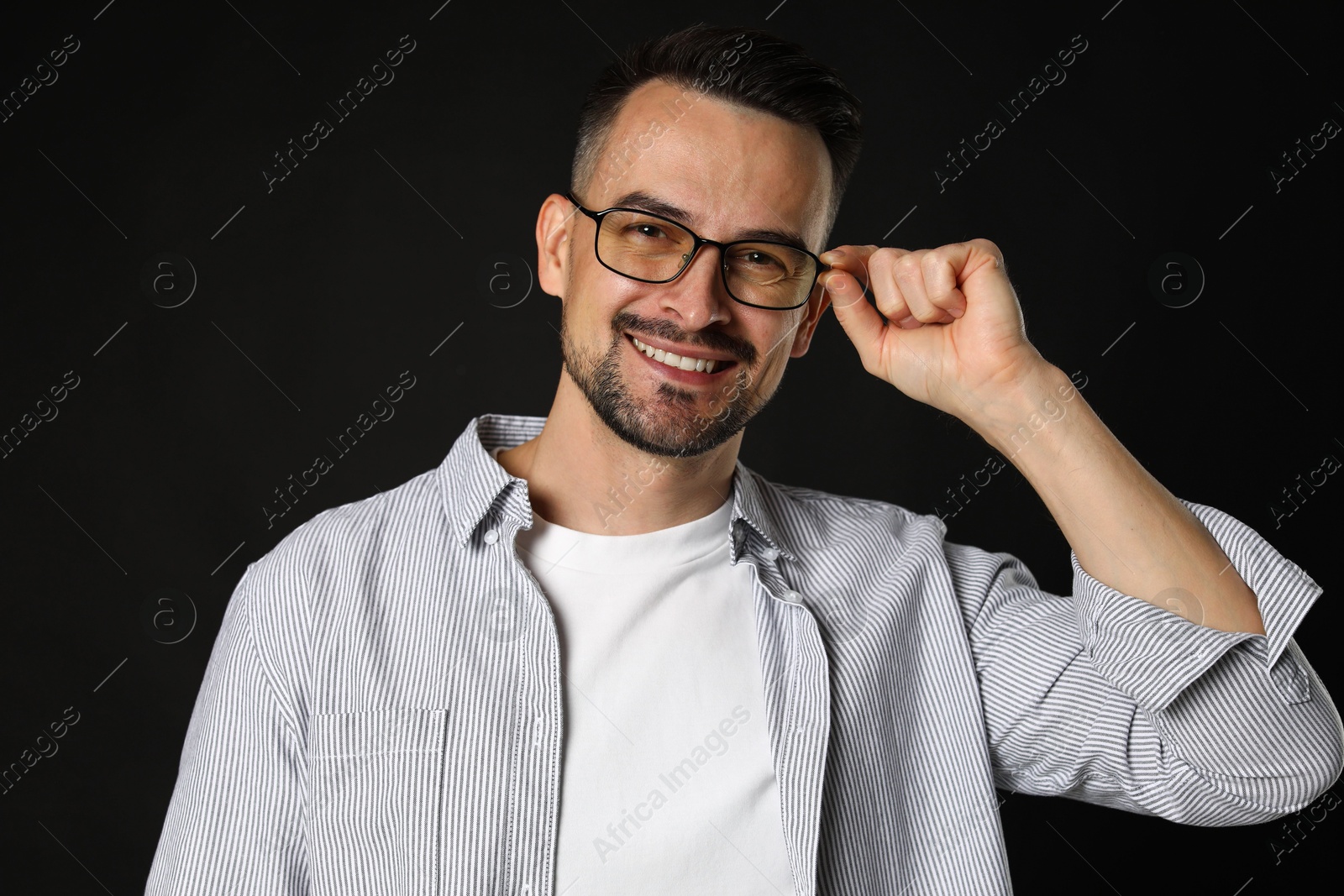 Photo of Portrait of handsome middle aged man on black background