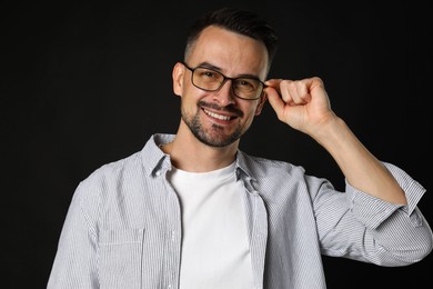 Photo of Portrait of handsome middle aged man on black background