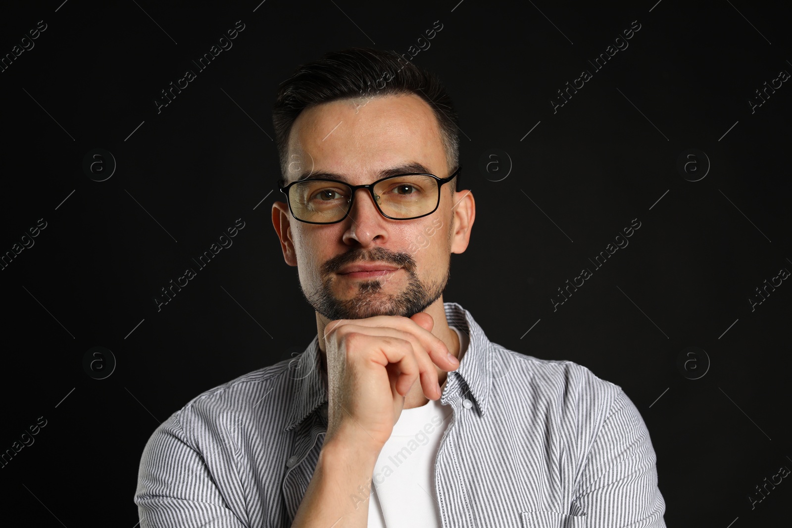 Photo of Portrait of handsome middle aged man on black background