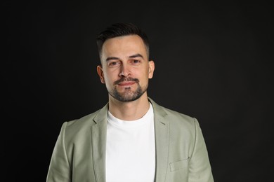 Photo of Portrait of handsome middle aged man on black background