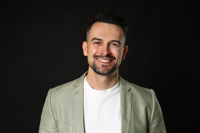 Photo of Portrait of handsome middle aged man on black background