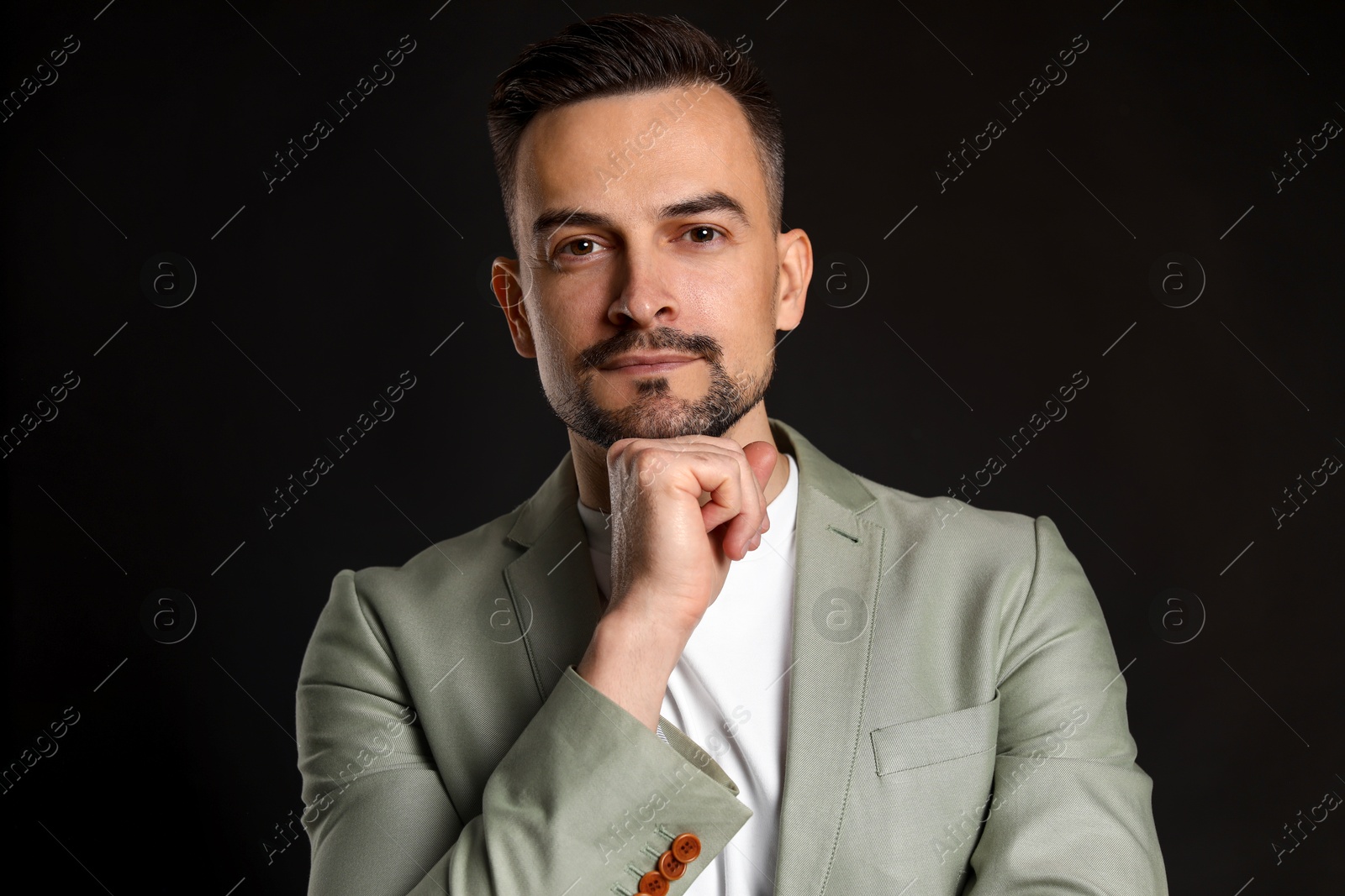 Photo of Portrait of handsome middle aged man on black background