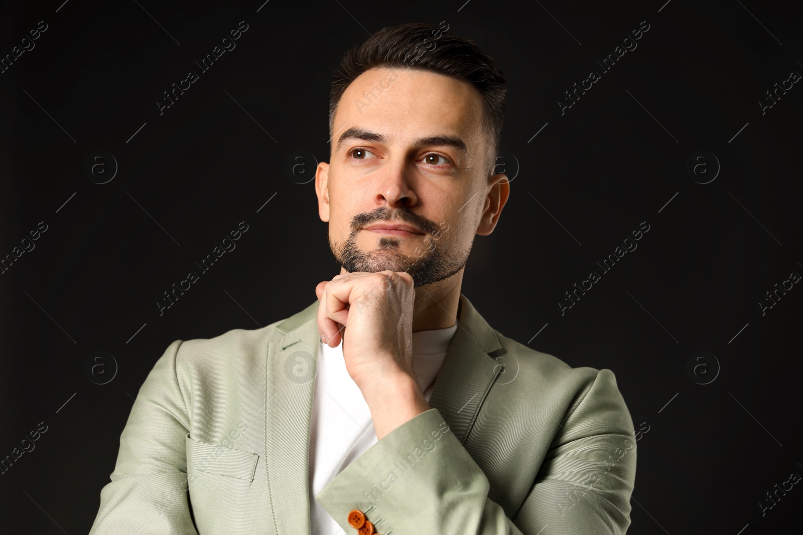 Photo of Portrait of handsome middle aged man on black background