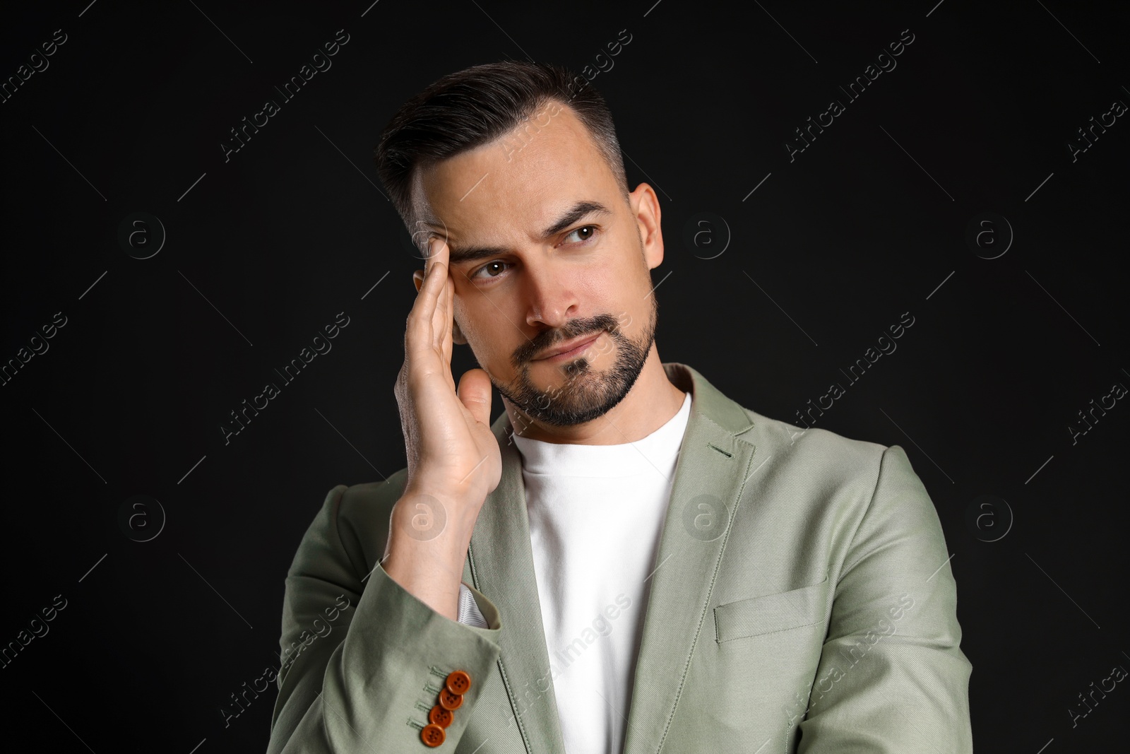 Photo of Portrait of handsome middle aged man on black background