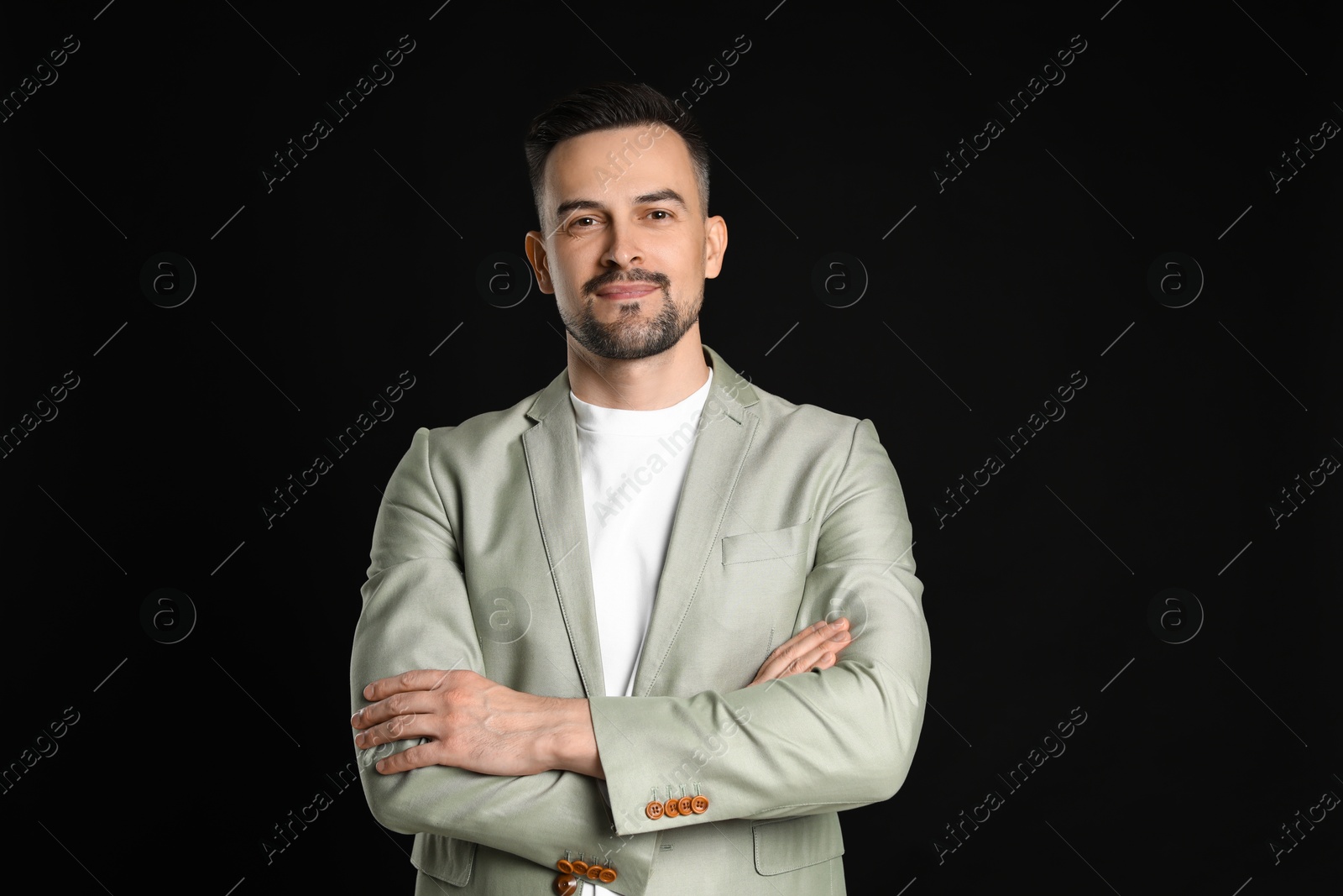 Photo of Portrait of handsome middle aged man on black background