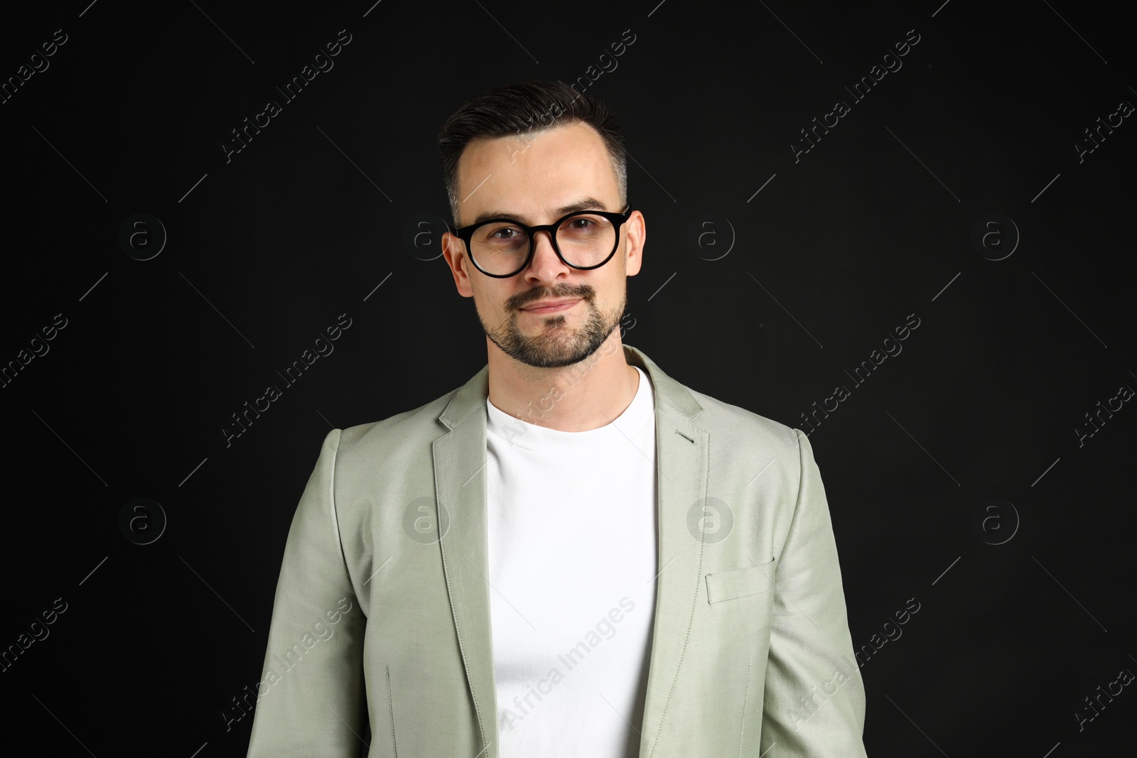 Photo of Portrait of handsome middle aged man on black background