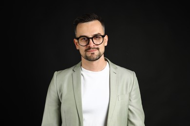 Portrait of handsome middle aged man on black background