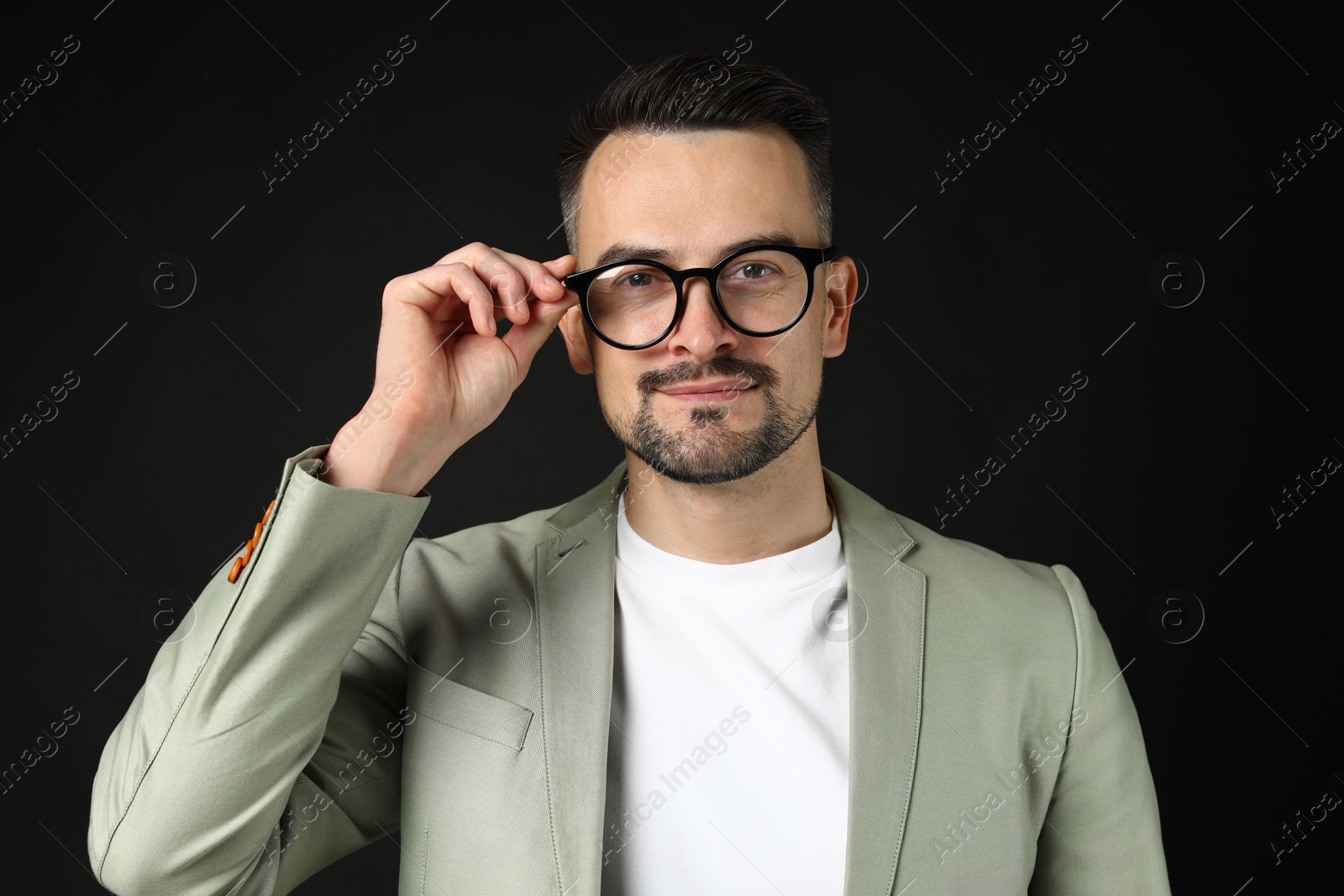 Photo of Portrait of handsome middle aged man on black background