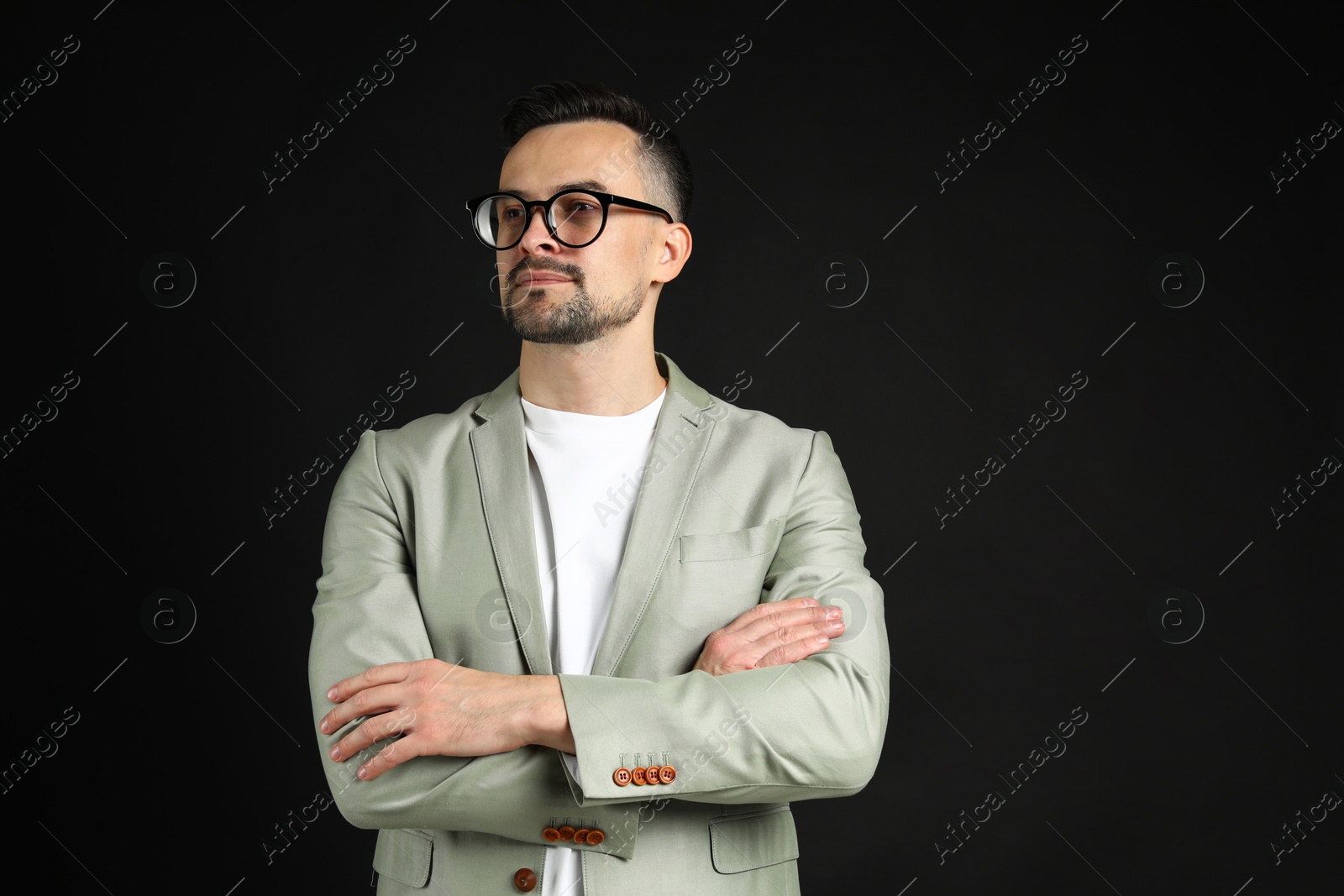 Photo of Portrait of handsome middle aged man on black background