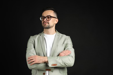 Portrait of handsome middle aged man on black background