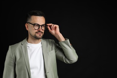 Photo of Portrait of handsome middle aged man on black background, space for text