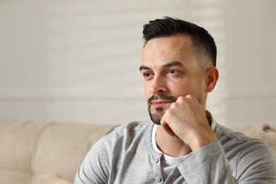 Photo of Portrait of handsome middle aged man indoors, space for text