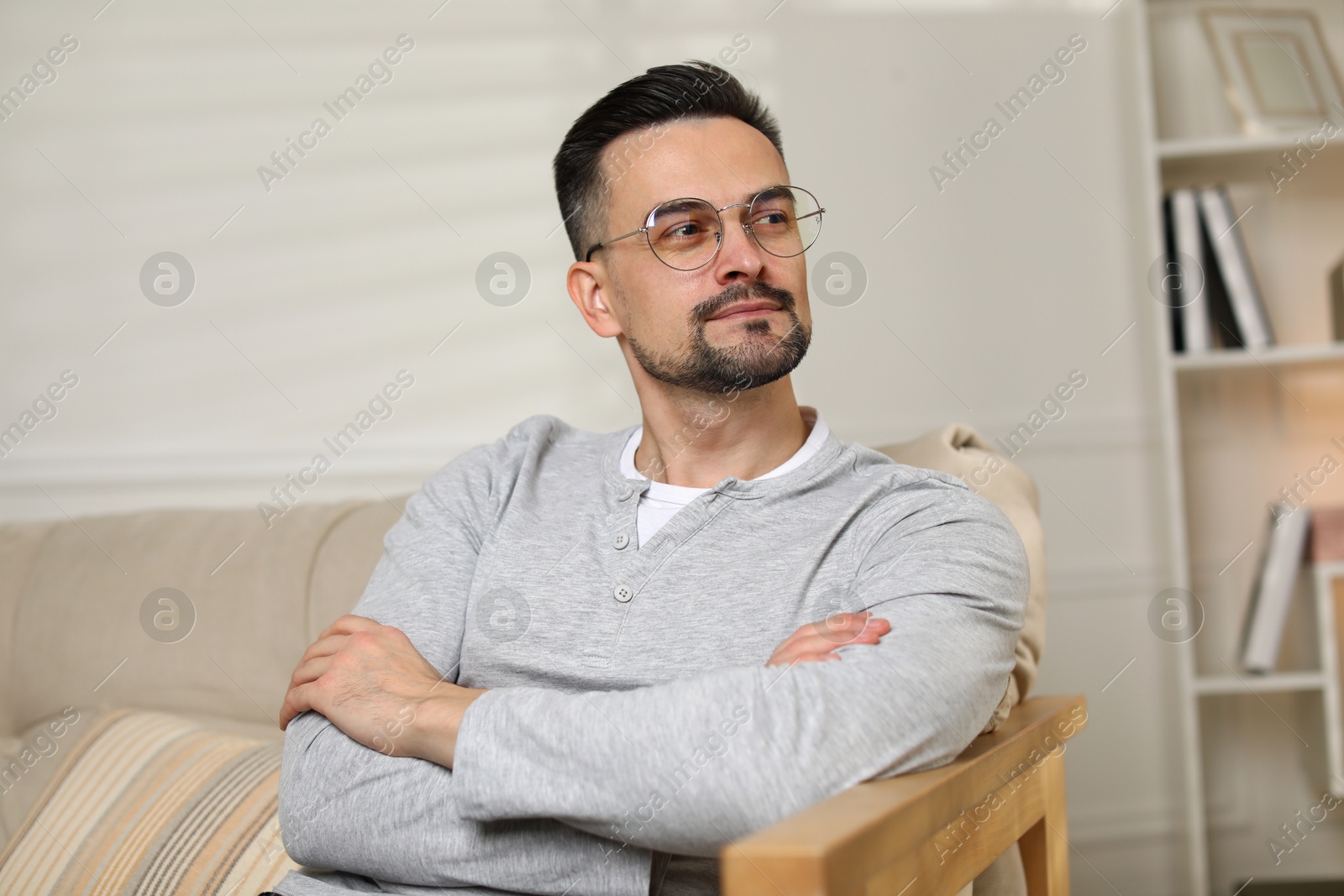 Photo of Handsome middle aged man on sofa indoors