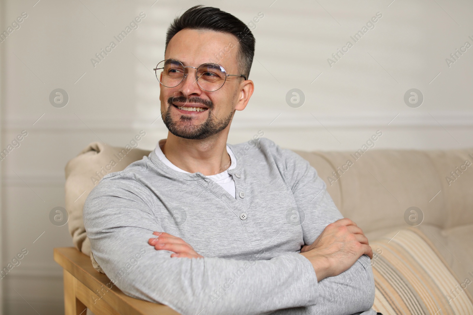 Photo of Handsome middle aged man on sofa indoors