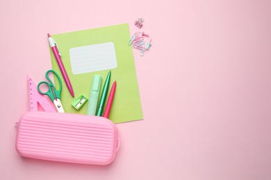 Photo of Copybook and other school stationery on pink background, flat lay. Space for text