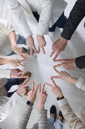 Photo of Unity concept. People showing V-sign with both hands and joining their fingers together in circle