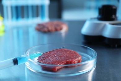 Photo of GMO concept. Minced meat and syringe on table in laboratory, closeup