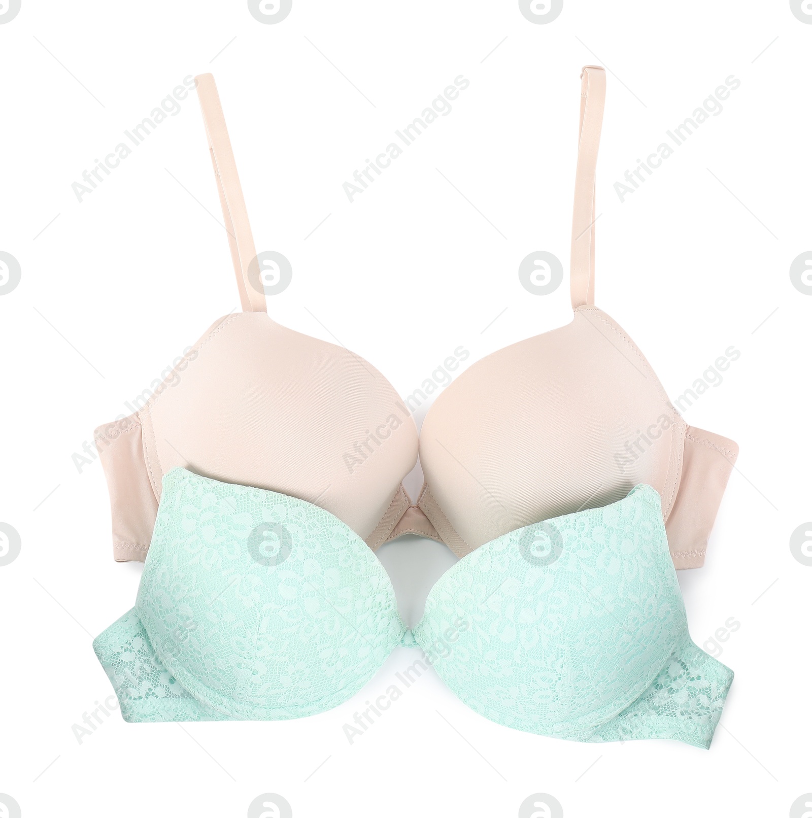 Photo of Two different beautiful bras isolated on white, top view