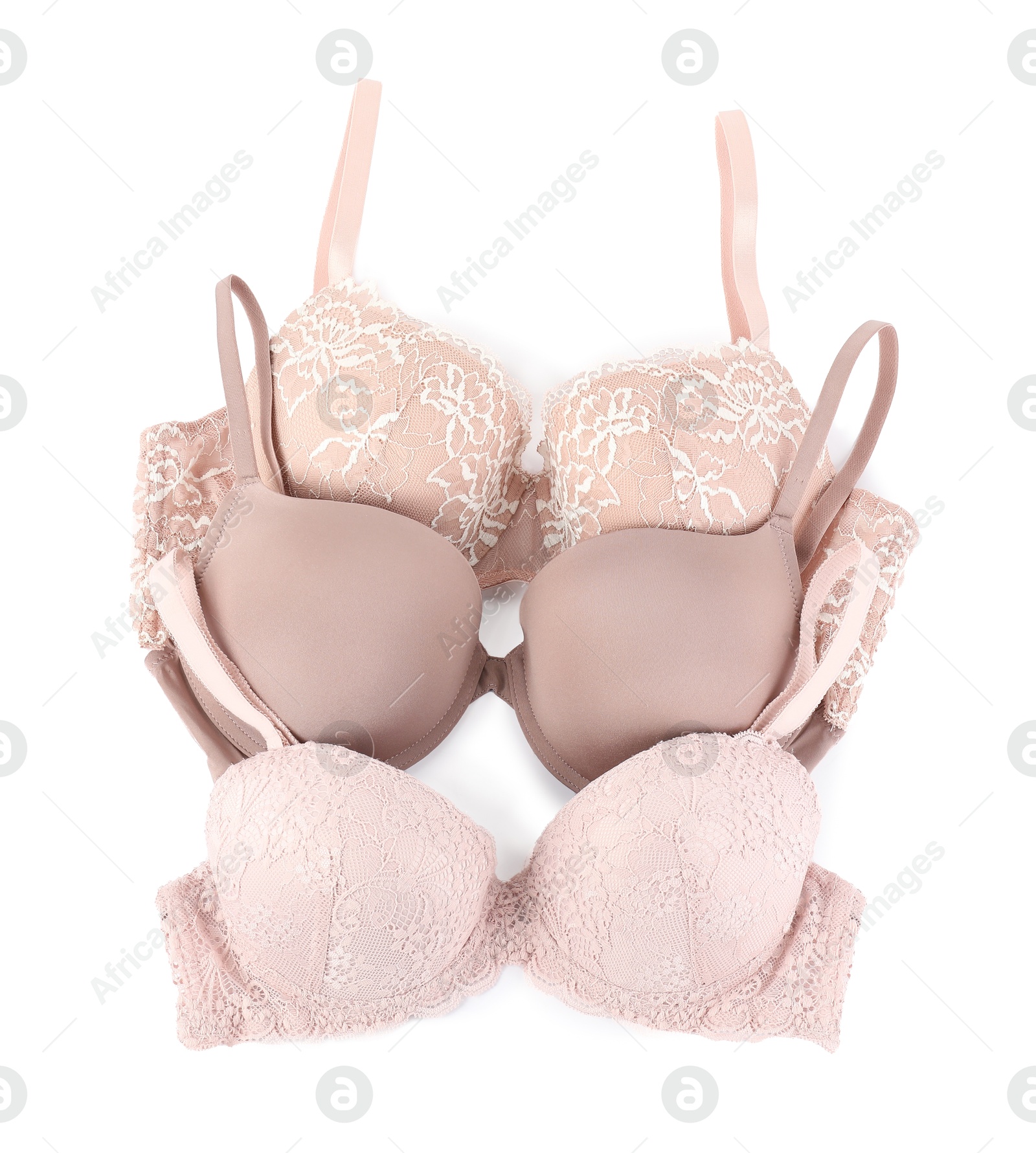 Photo of Three different beautiful bras isolated on white, top view