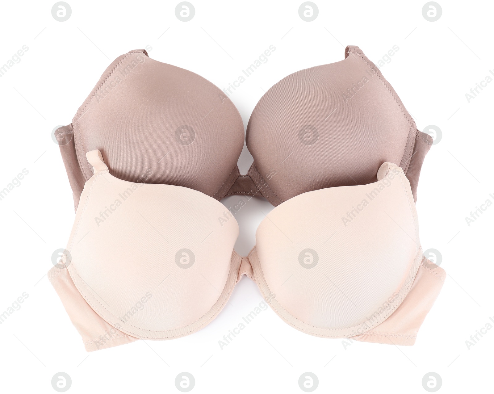 Photo of Two different beautiful bras isolated on white, top view