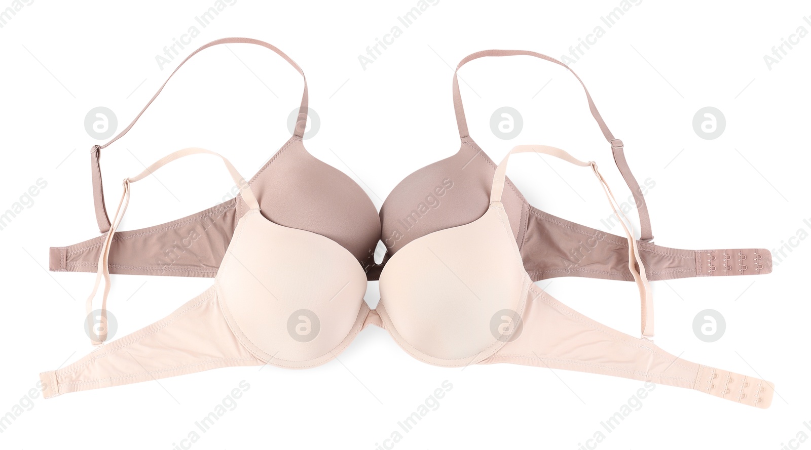 Photo of Two different beautiful bras isolated on white, top view