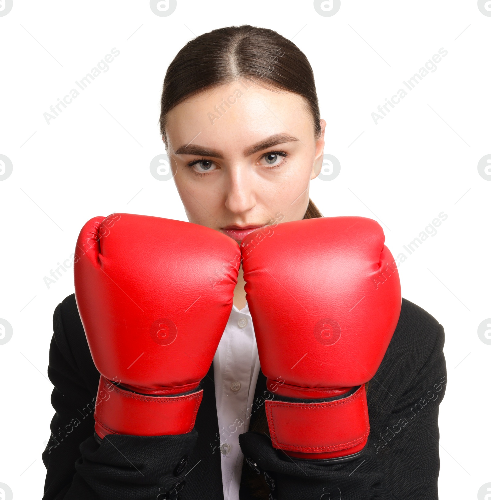 Photo of Competition. Businesswoman in suit wearing boxing gloves on white background