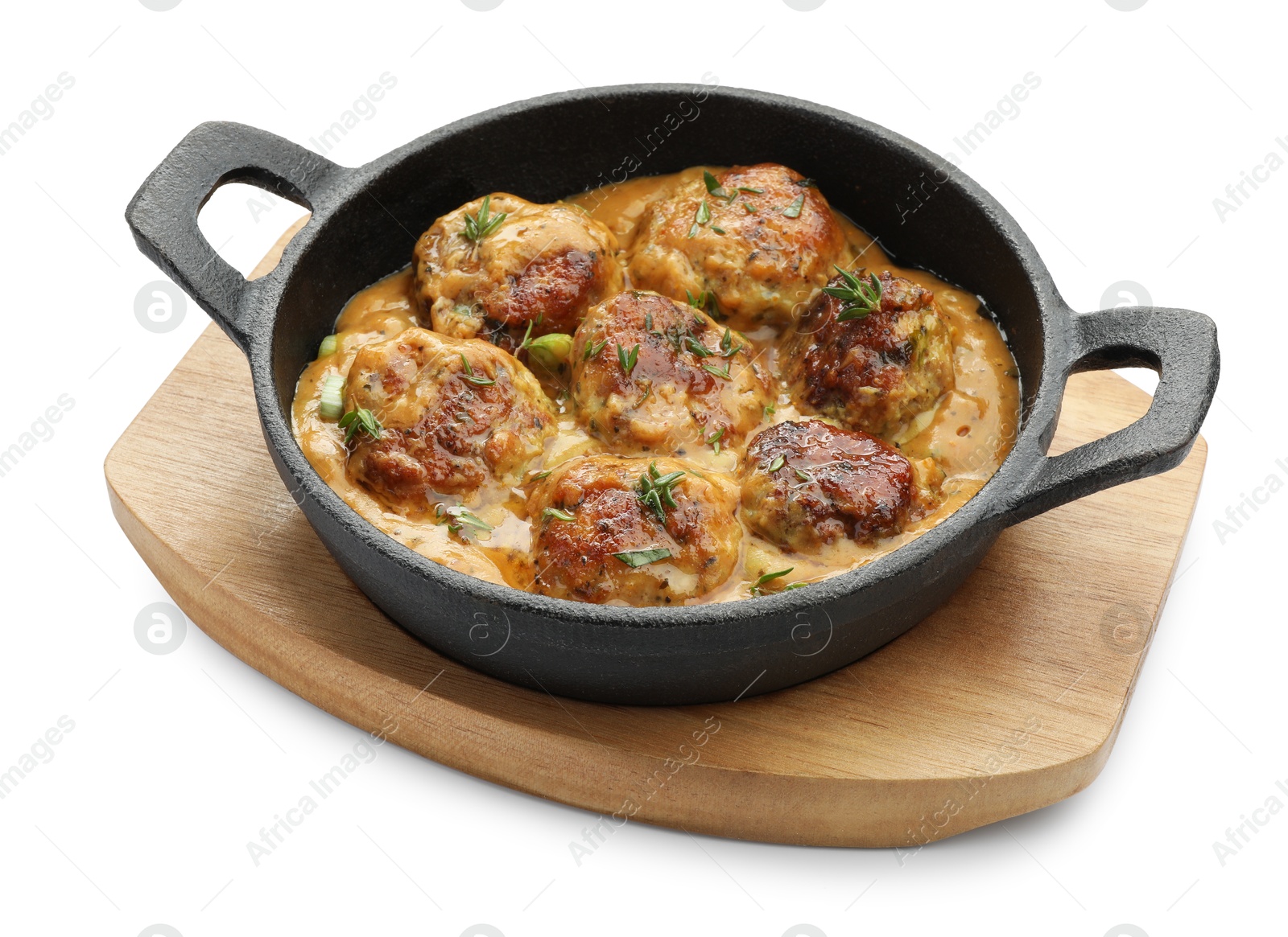 Photo of Delicious meatballs with gravy cream sauce and herbs isolated on white