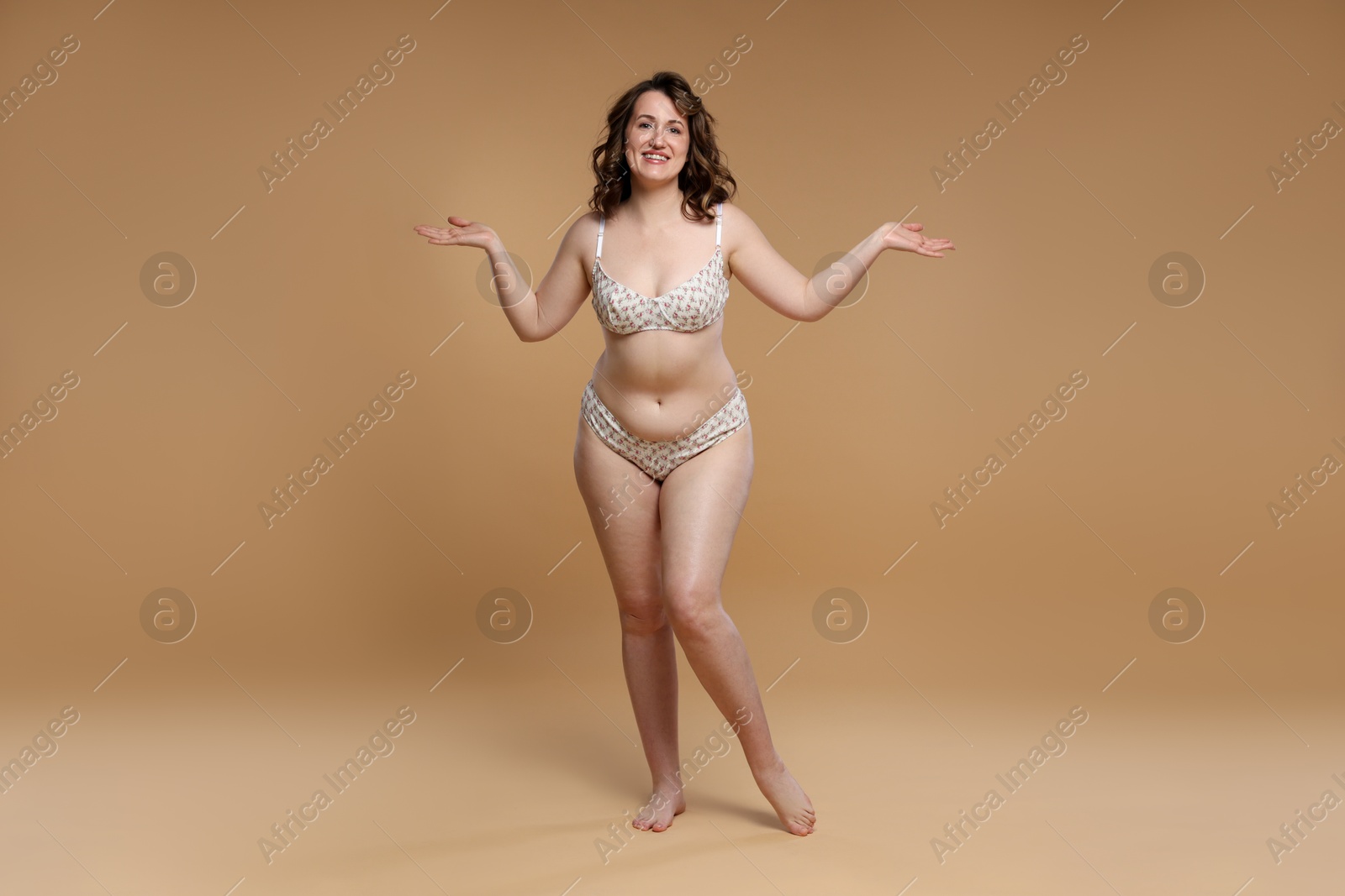 Photo of Beautiful woman in underwear on dark beige background. Cellulite problem