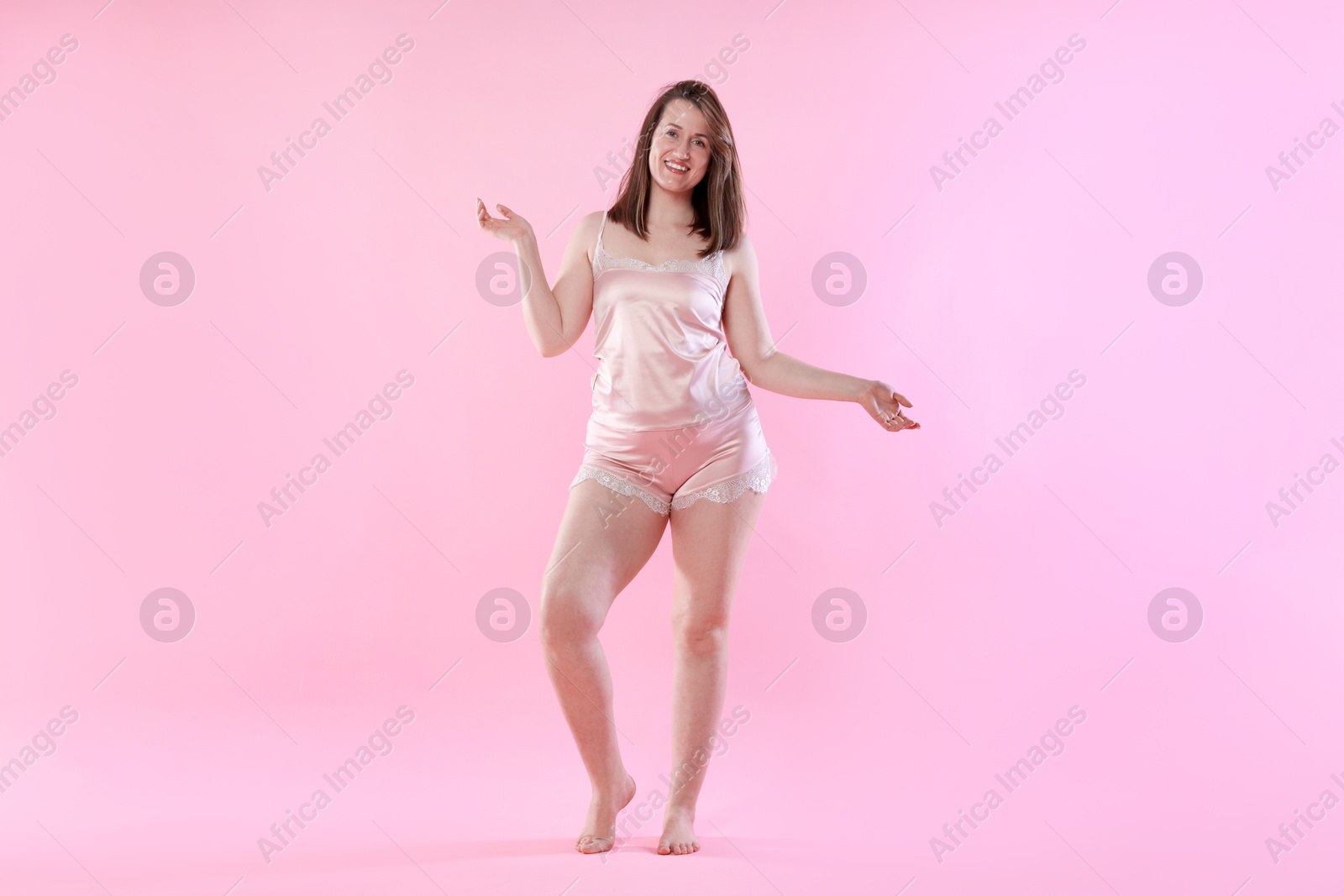 Photo of Woman in underwear on pink background. Cellulite problem