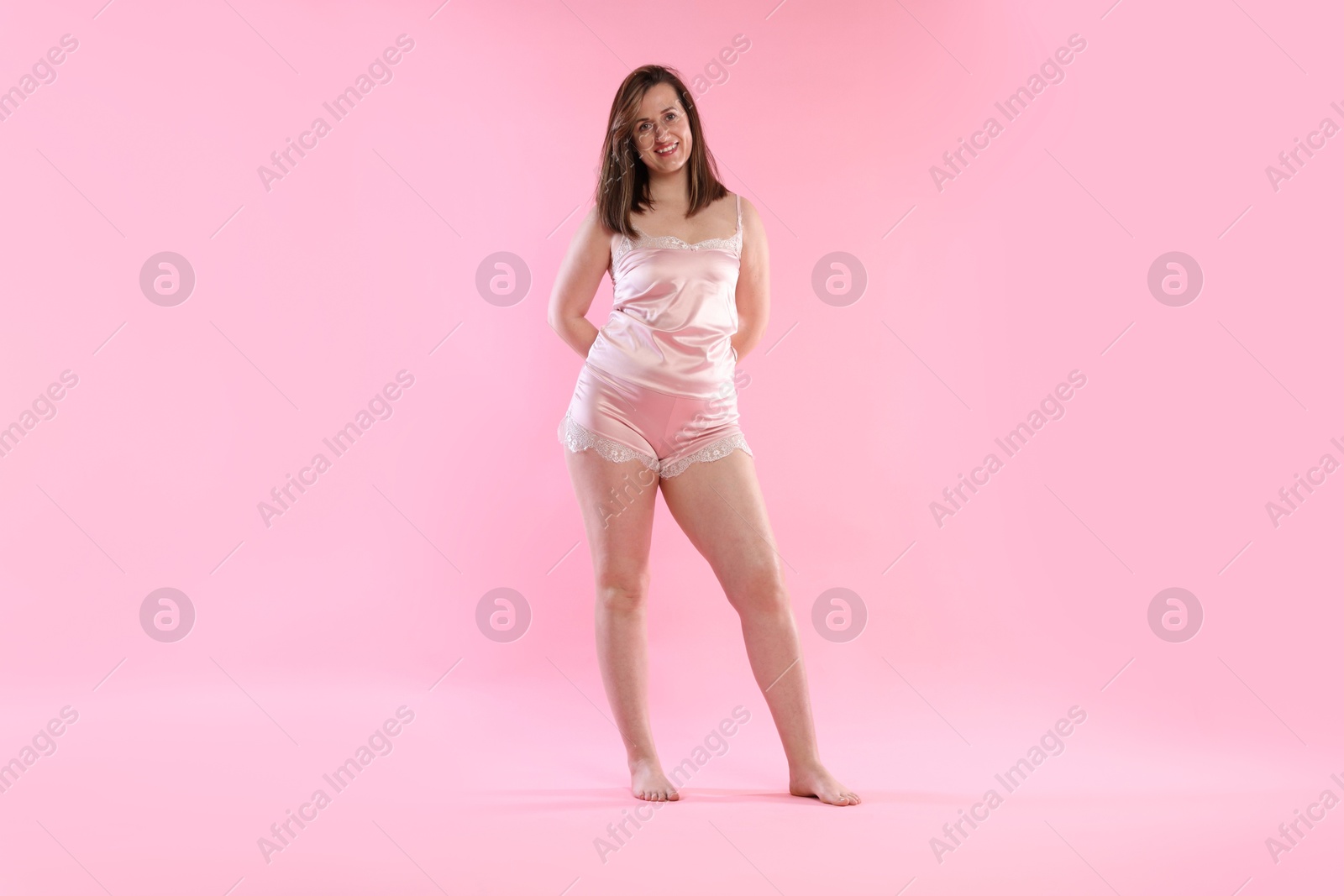 Photo of Woman in underwear on pink background. Cellulite problem