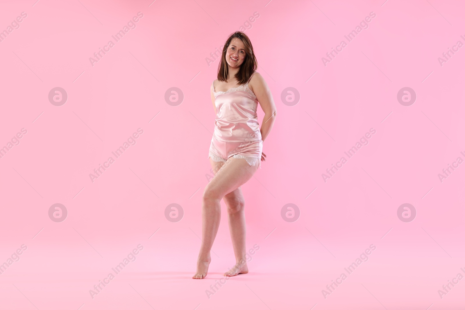 Photo of Woman in underwear on pink background. Cellulite problem