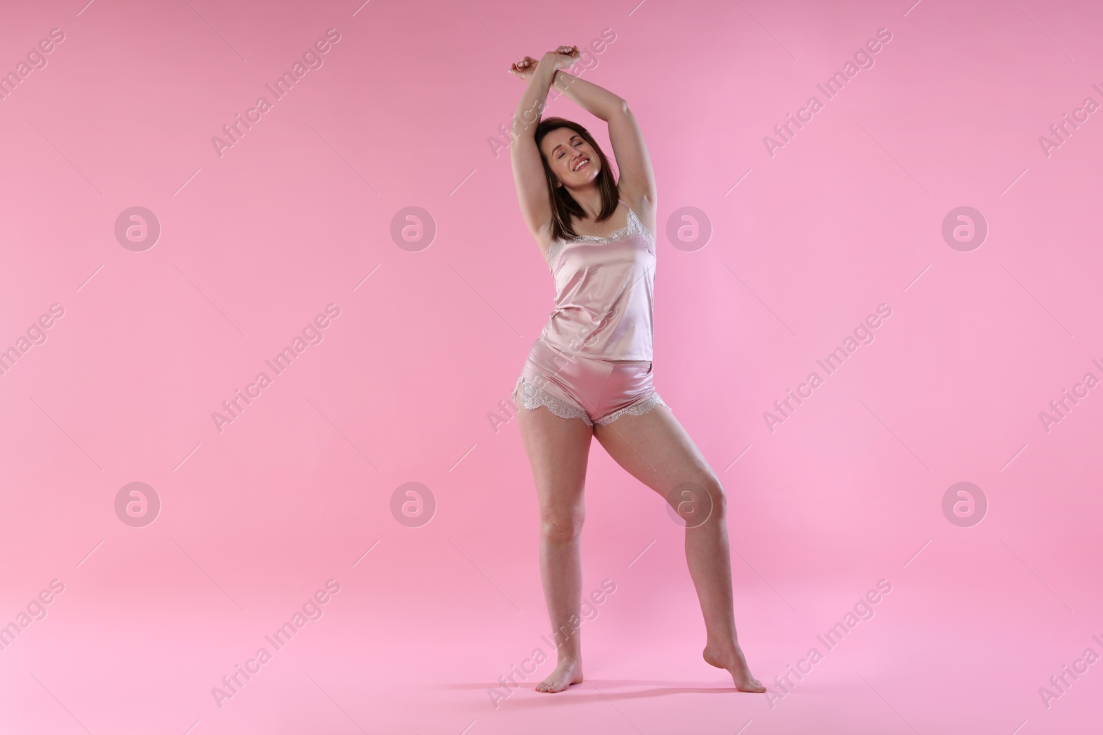 Photo of Woman in underwear on pink background. Cellulite problem