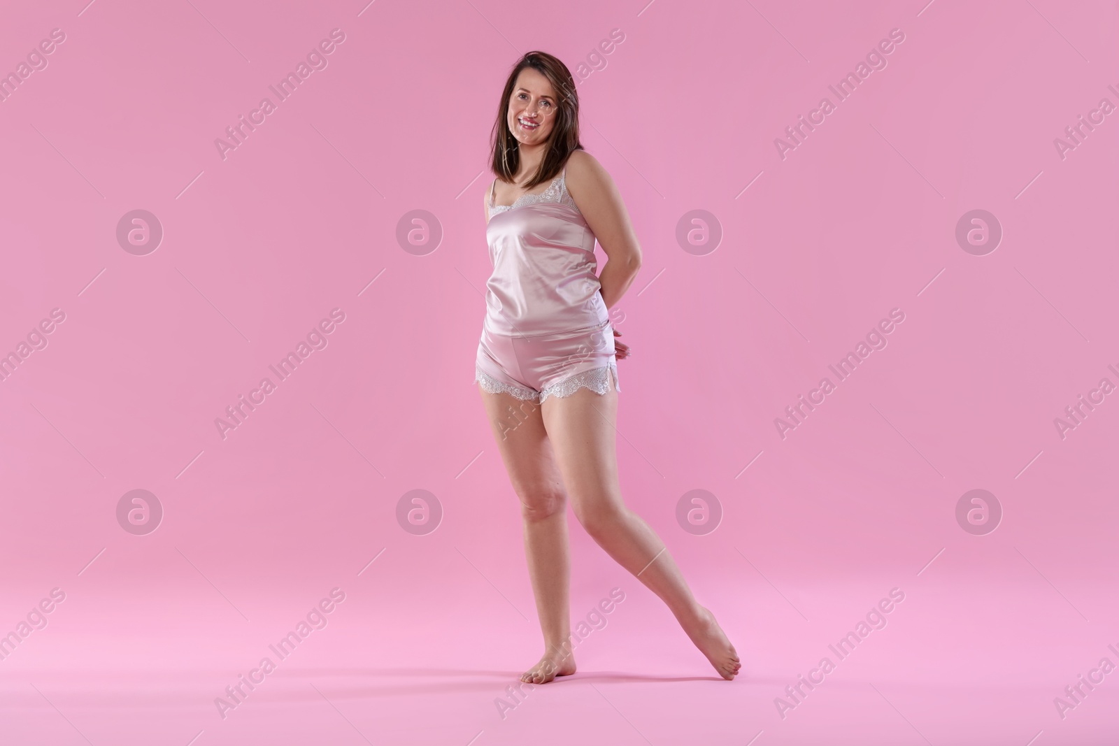 Photo of Woman in underwear on pink background. Cellulite problem