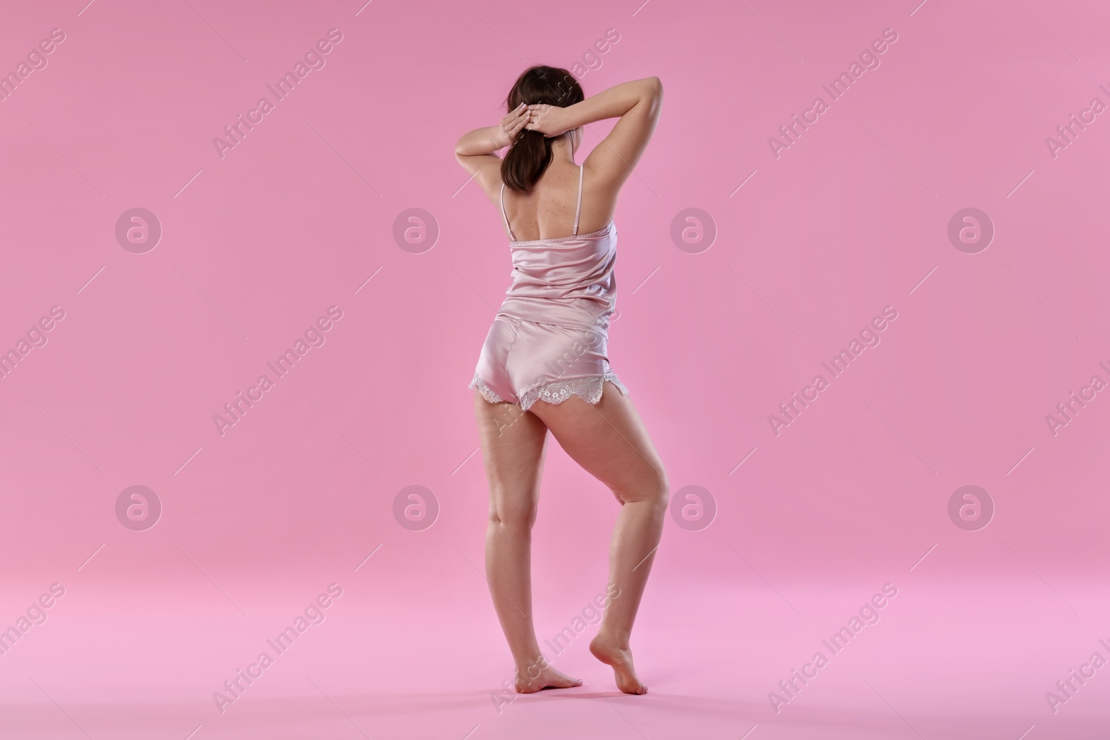 Photo of Woman in underwear on pink background. Cellulite problem