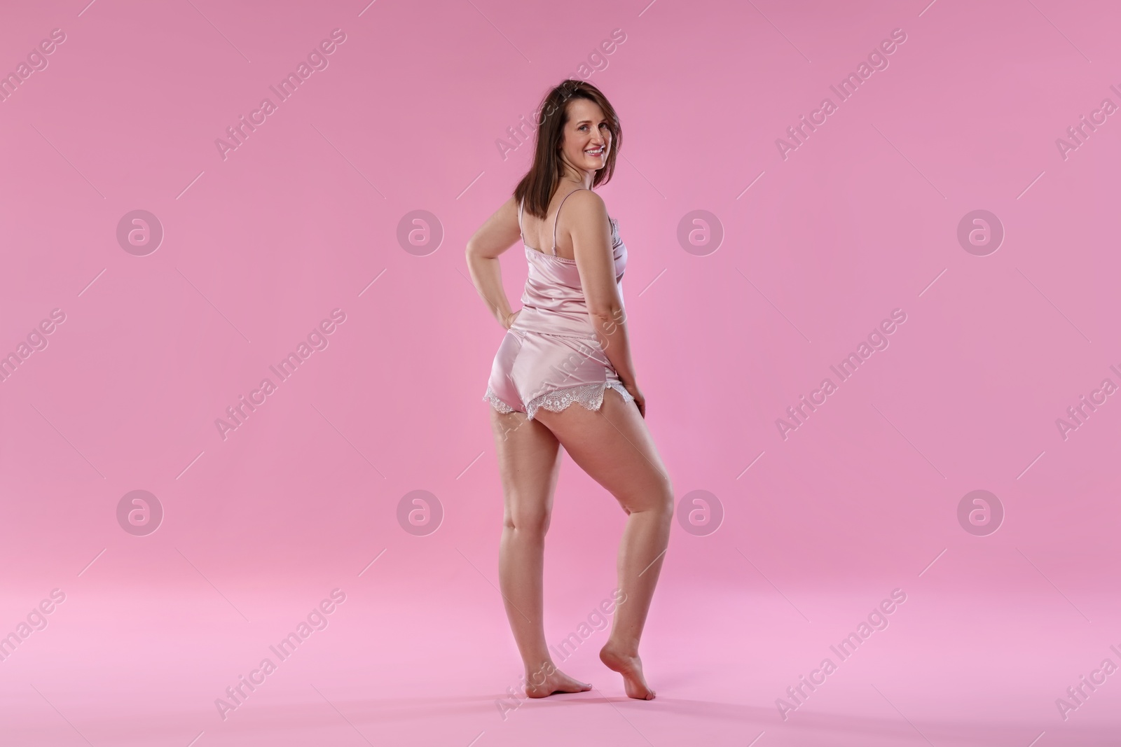 Photo of Woman in underwear on pink background. Cellulite problem