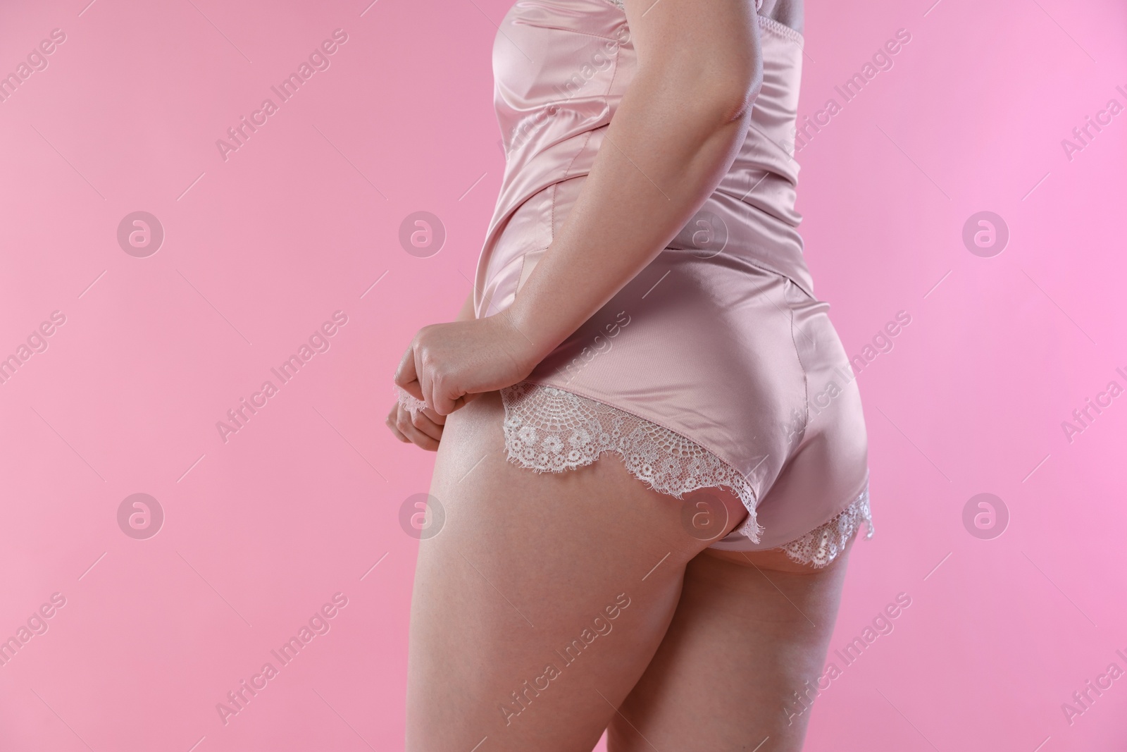 Photo of Woman in underwear on pink background, closeup. Cellulite problem