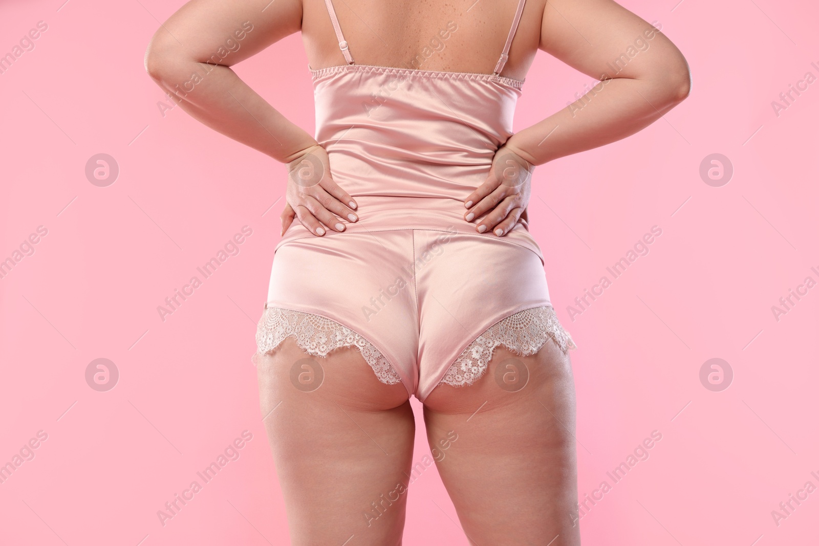 Photo of Woman in underwear on pink background, closeup. Cellulite problem