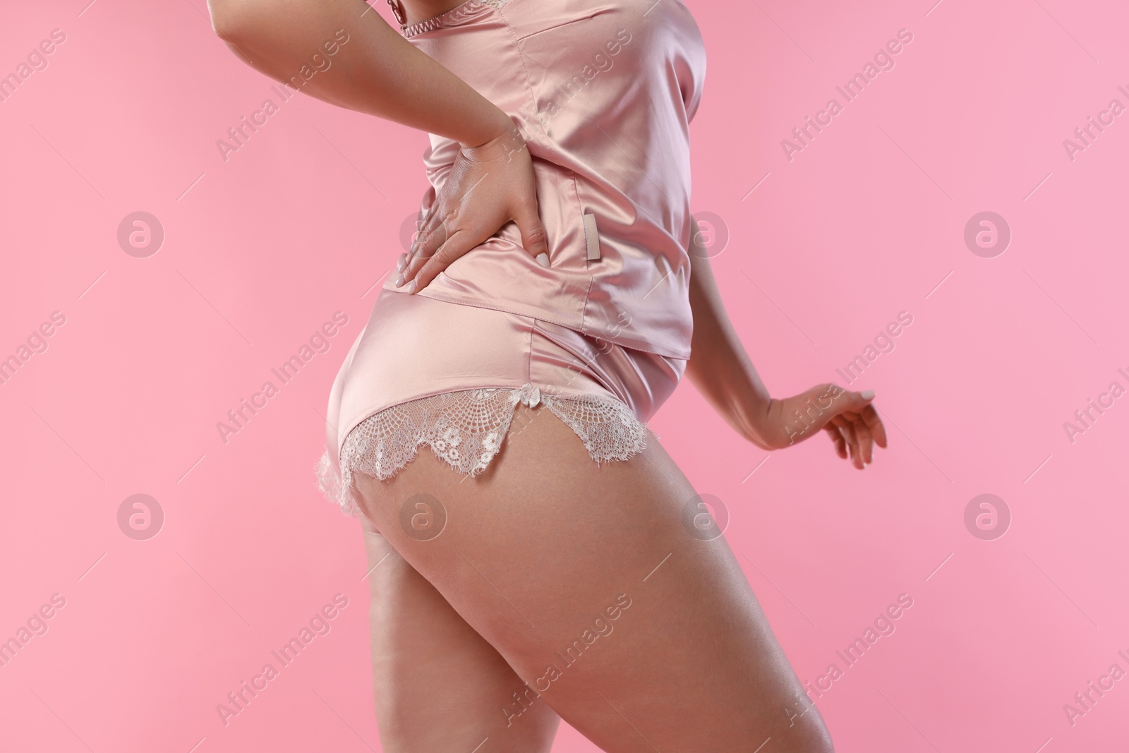 Photo of Woman in underwear on pink background, closeup. Cellulite problem