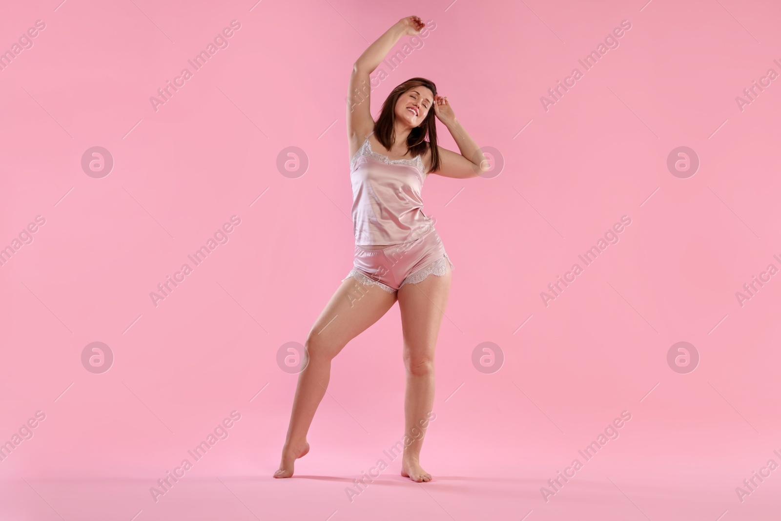 Photo of Woman in underwear on pink background. Cellulite problem