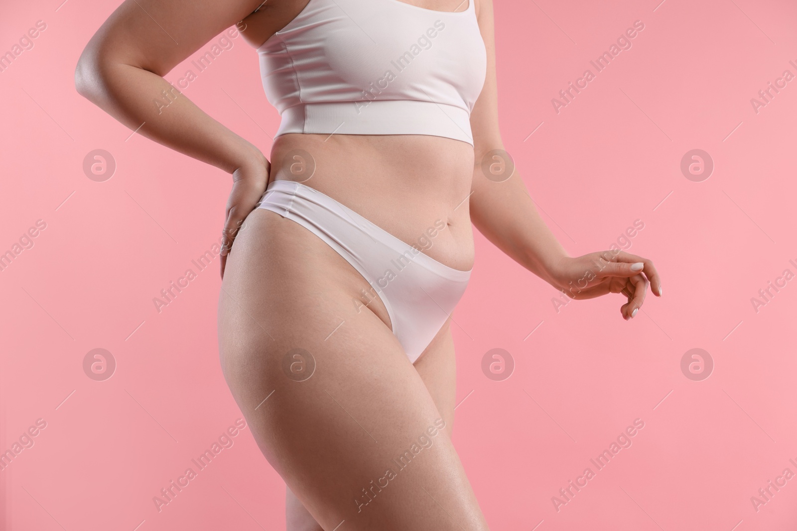 Photo of Woman with cellulite on pink background, closeup