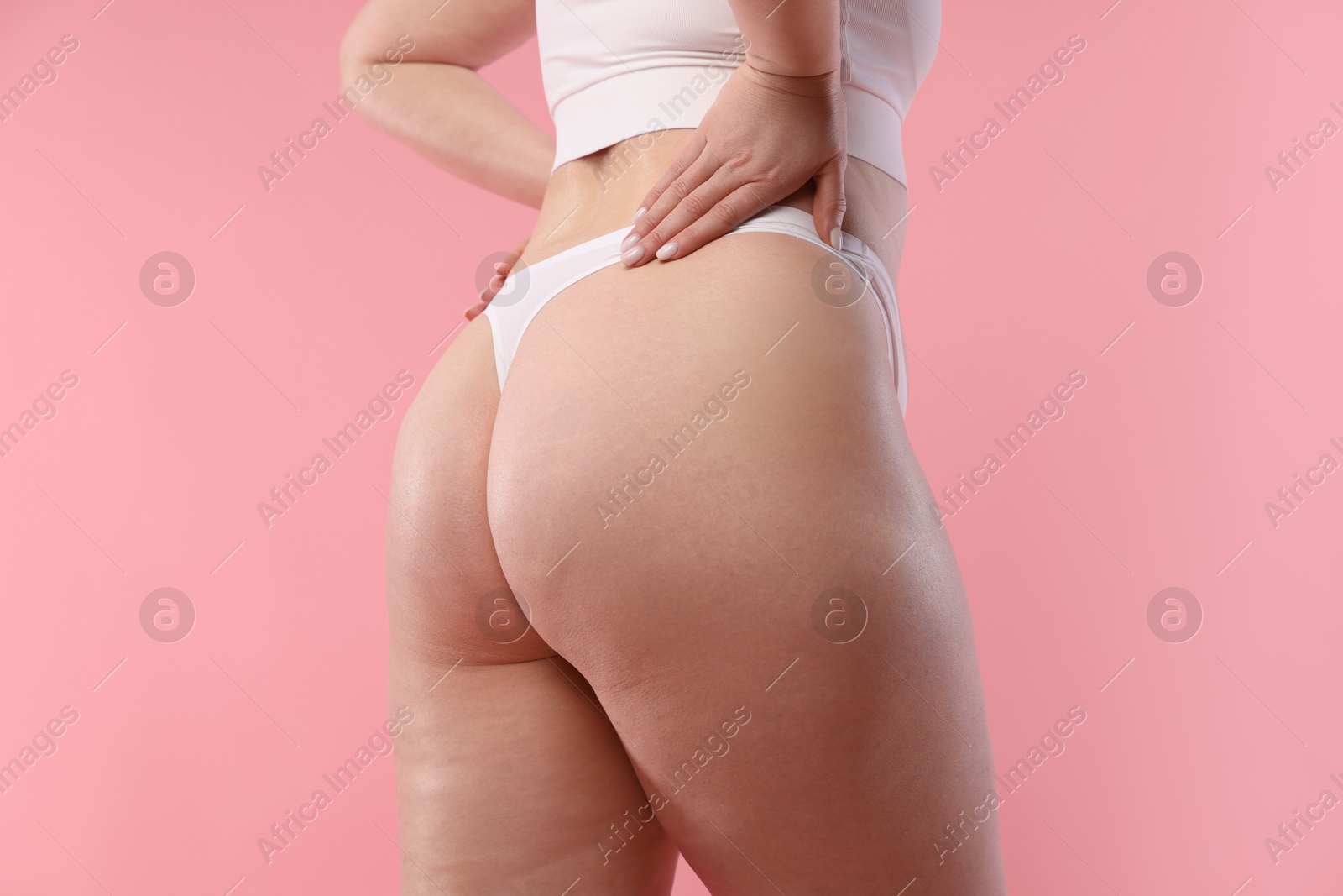 Photo of Woman with cellulite on pink background, closeup