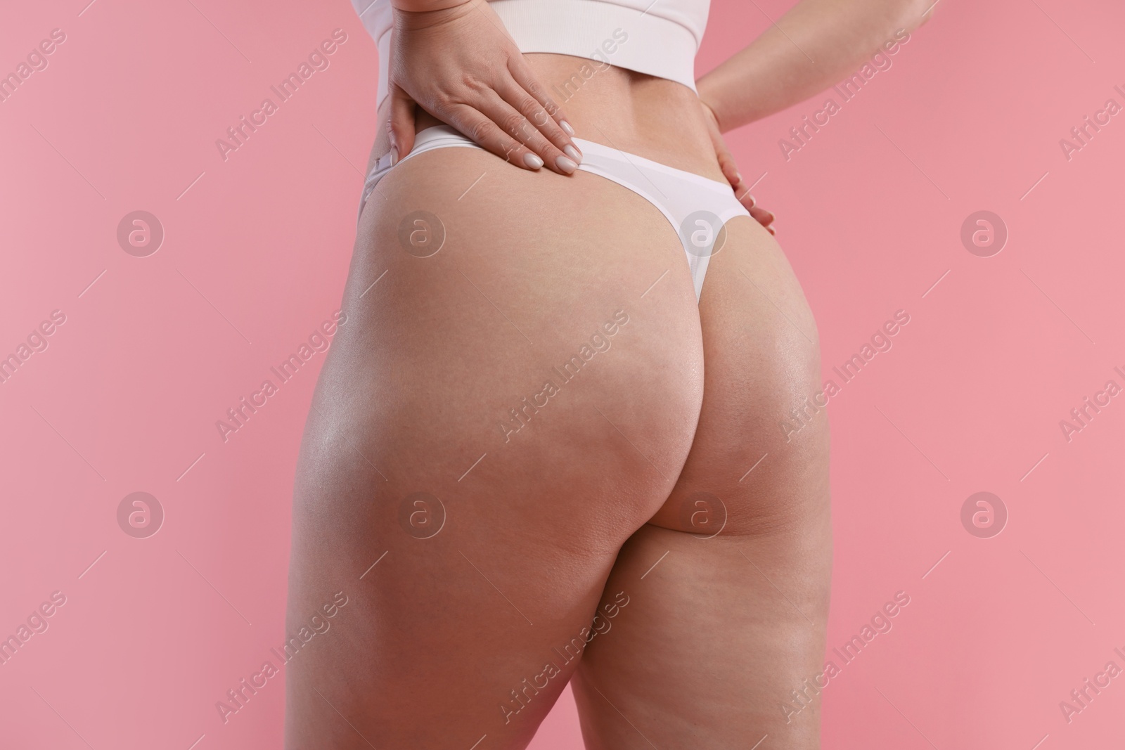 Photo of Woman with cellulite on pink background, closeup