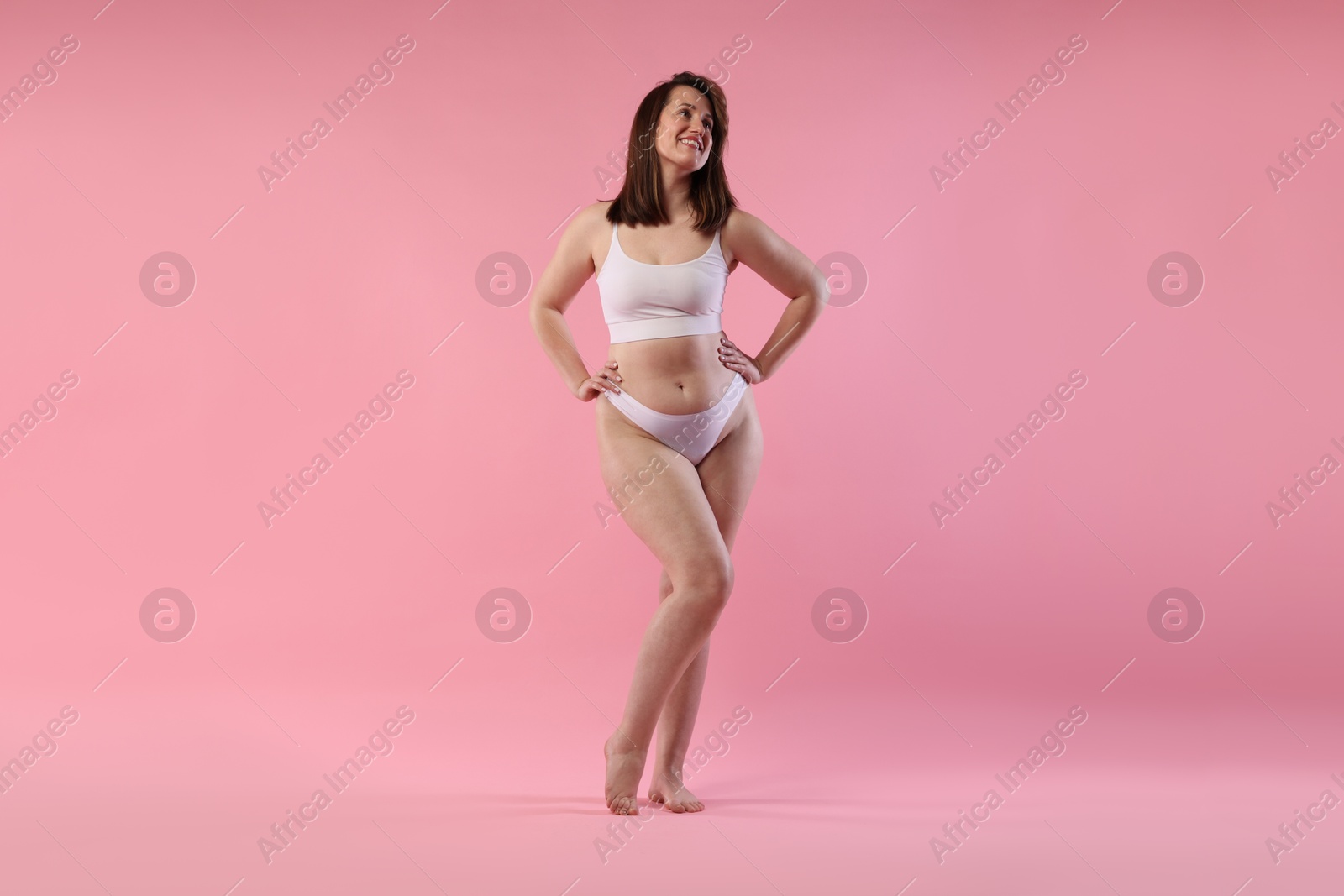 Photo of Woman in underwear on pink background. Cellulite problem