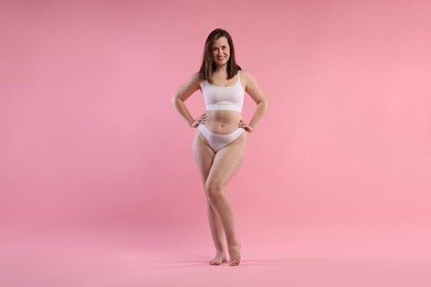 Photo of Woman in underwear on pink background. Cellulite problem