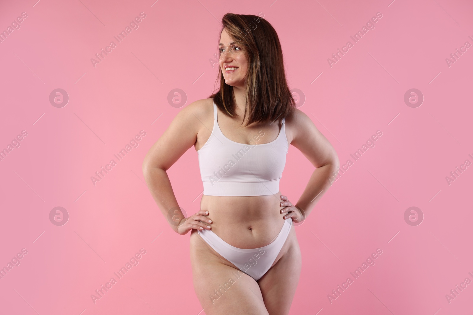 Photo of Woman in underwear on pink background. Cellulite problem