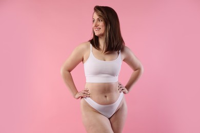 Photo of Woman in underwear on pink background. Cellulite problem